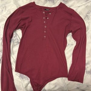 Long sleeve burgundy bodysuit.